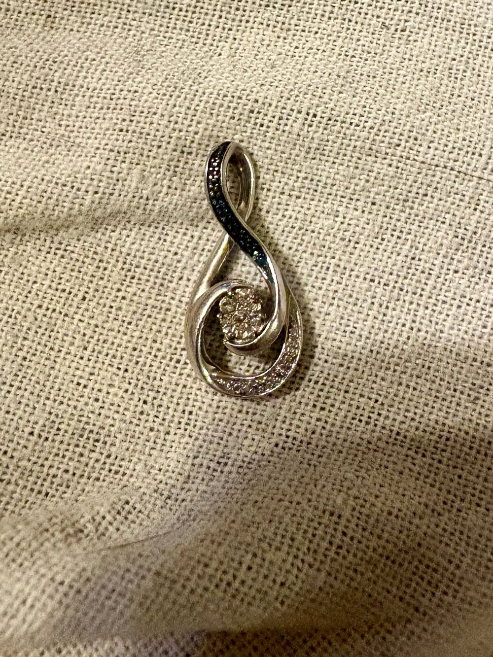 Black & white diamond accent cluster infinity pendant in sterling silver.